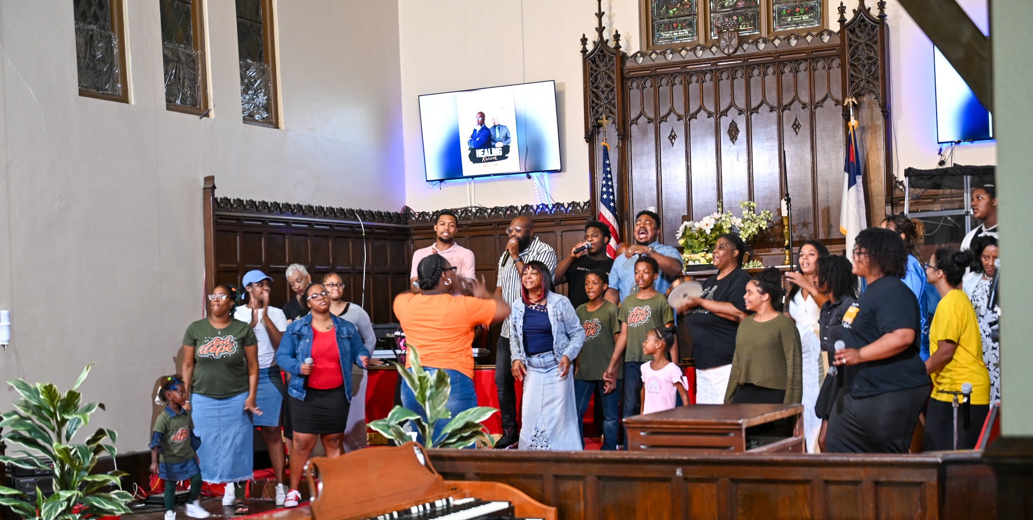 Pilgrim Church of Christ worship service with congregation praising